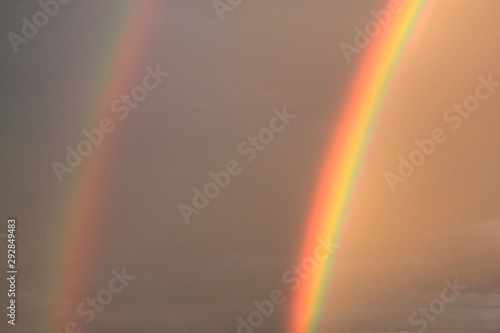 bright double rainbow against a stormy sky