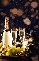 New year celebration with grapes and champagne