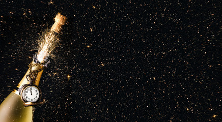 New year party with an exploding bottle of champagne