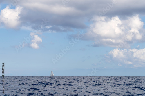 Alone classic yacht sailing in open sea