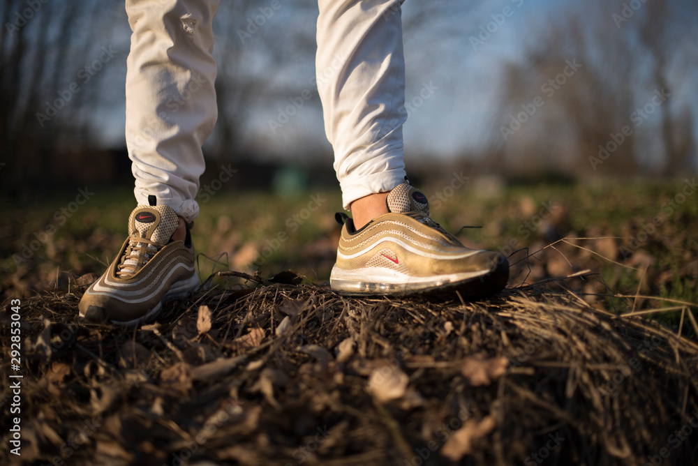 Nike Air Max 97 Gold shoes in the street Stock Photo | Adobe Stock