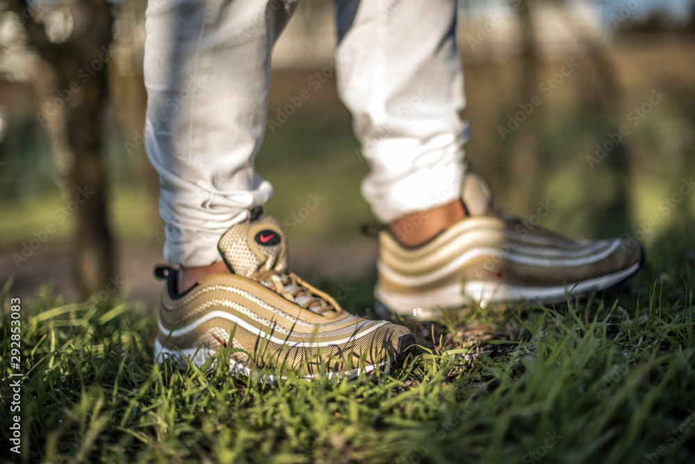 Nike Air Max 97 Gold shoes in the street Stock Photo | Adobe Stock