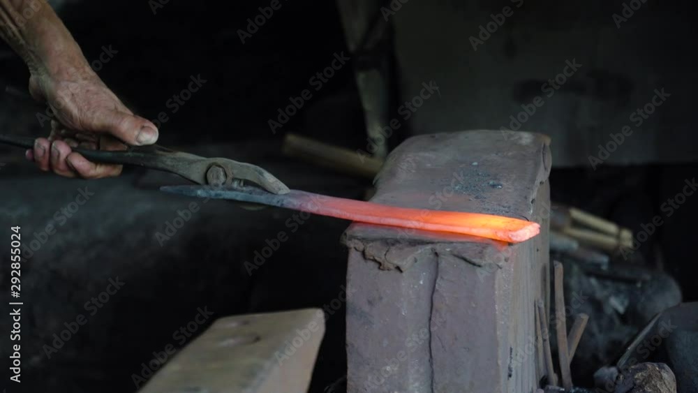 blacksmith forging red-hot metal with hammer. Anvil in the forge. blacksmith forging red-hot metal with hammer. Anvil in the forge.