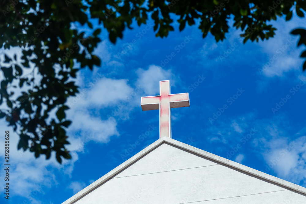 Faded cross on church roof