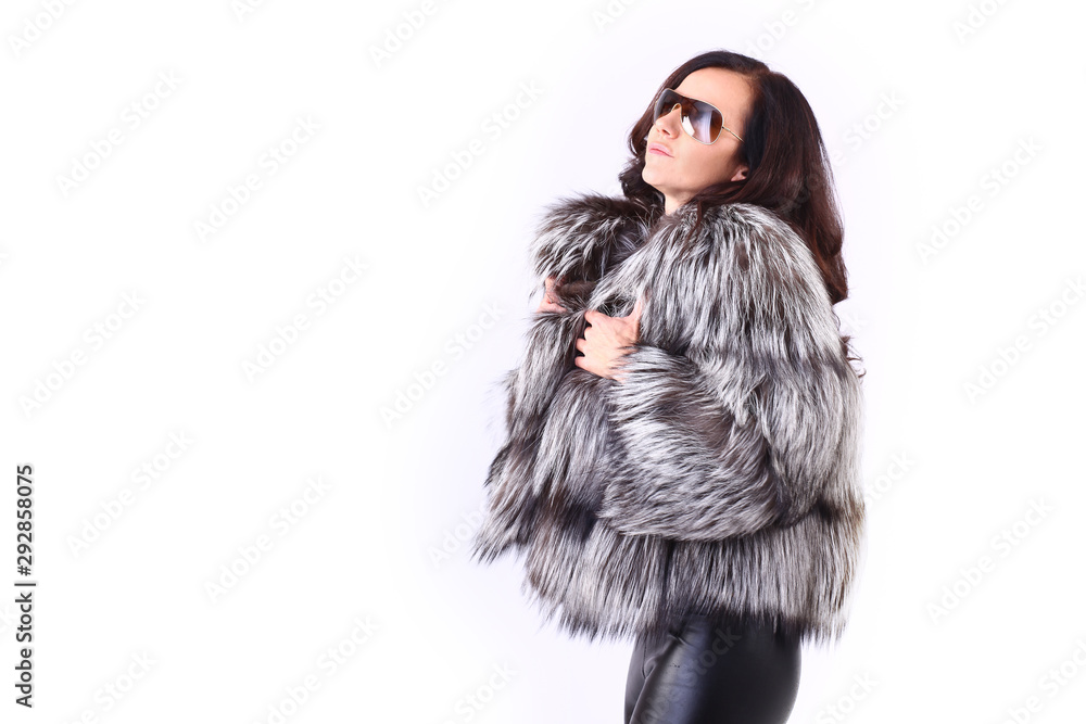 Woman with expensive fur coat and pretty ling hair with sun glasses
