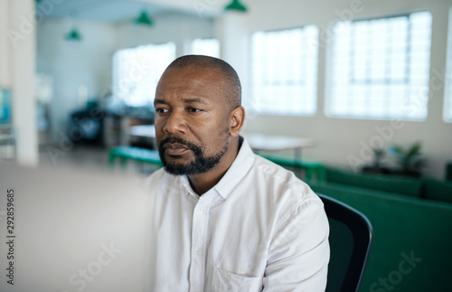 African American businessman working on a computer in an office