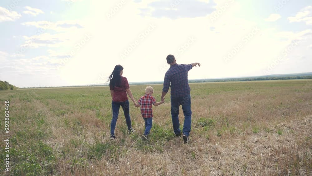 happy family teamwork friendship care concept slow motion video. father mom and son walk in nature sunset sunlight hold hand. happy family parents lifestyle man and girl hold little boy walking hand happy family teamwork friendship care concept slow motion video. father mom and son walk in nature sunset sunlight hold hand. happy family parents lifestyle man and girl hold little boy walking hand