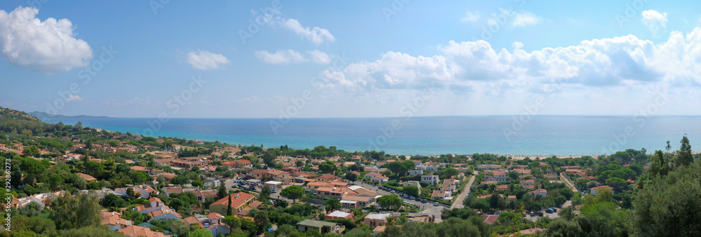 amazing panorama view seascape and landscape in the south coast of sardinia shoreline in a sunny day with clear blue sky and clouds.