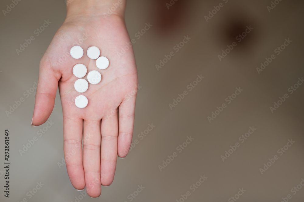 The letter P laid out by tablets on a female hand The letter P laid out by tablets on a female hand