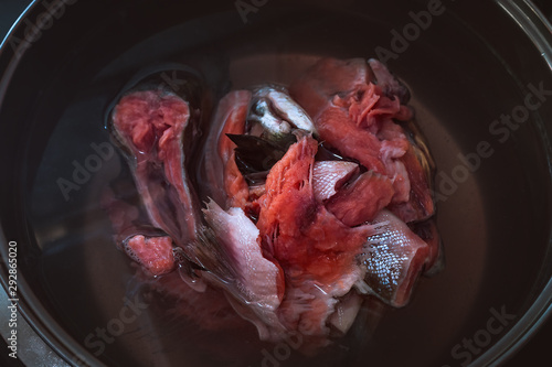 Salmon Head and Frame in a Metal Pan before Boiling. Preparing Salmon Fish Head Soup. photo