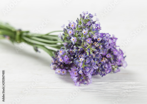 Wellness treatments with lavender flowers on wooden table. Spa still-life.