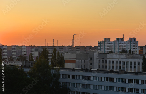 View of the facades of the houses from the roof of a high-rise building. Gomel city in the sunset light.