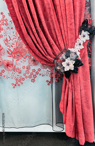 Red velvet curtains with tie-back from lace flowers and the transparend tulle with embroidery photo