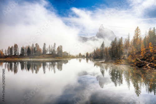 Dramatic foggy autumn landscape. View on Federa Lake early in the morning at autumn