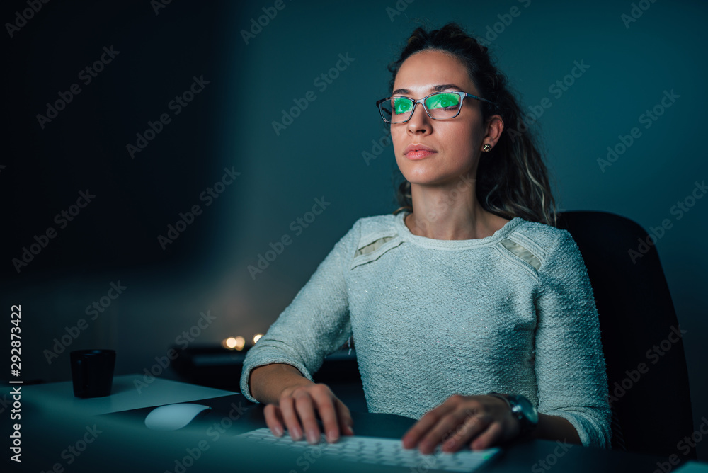 Young woman studying at night, front view, close-up. Young woman studying at night, front view, close-up.
