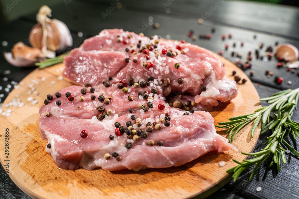Raw beef steak on a dark wooden table Raw beef steak on a dark wooden table