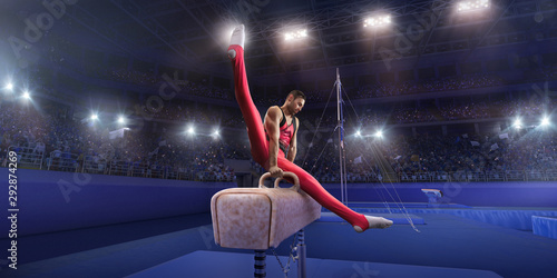 Male athlete doing a complicated exciting trick on a Pommel horse in a professional gym. Man perform stunt in bright sports clothes © Alex