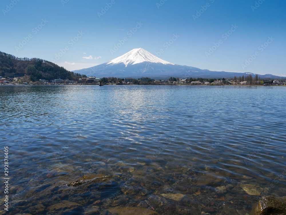 Natural landscape view of the Kawaguchi Lake with mount Fuji-the most beautiful vocano in Japan and rock under water in  foreground