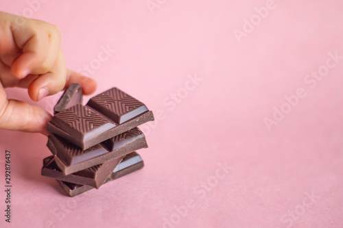 Child's hand taking a piece of chocolate.