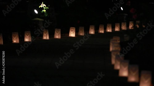 Paper bag lanterns on stairs. Candle light. Pierced in a heart shape. Romantic decoration photo