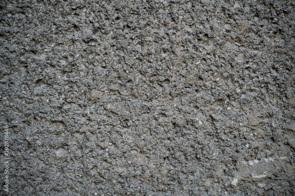 Texture of an old cracked concrete wall. Background image of a worn gray concrete surface Texture of an old cracked concrete wall. Background image of a worn gray concrete surface