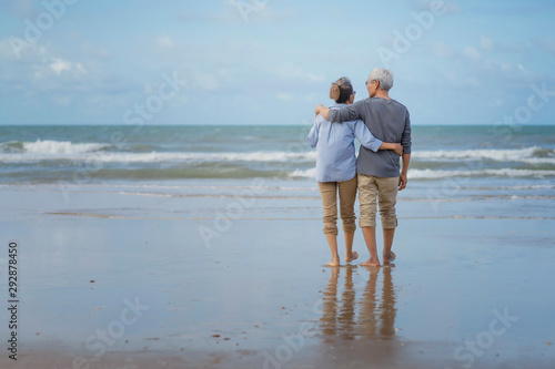 Asian couple senior elder retire resting relax walking running at the beach.Honeymoon family together happiness people lifestyle.Mature couples relax at the seaside on holiday.