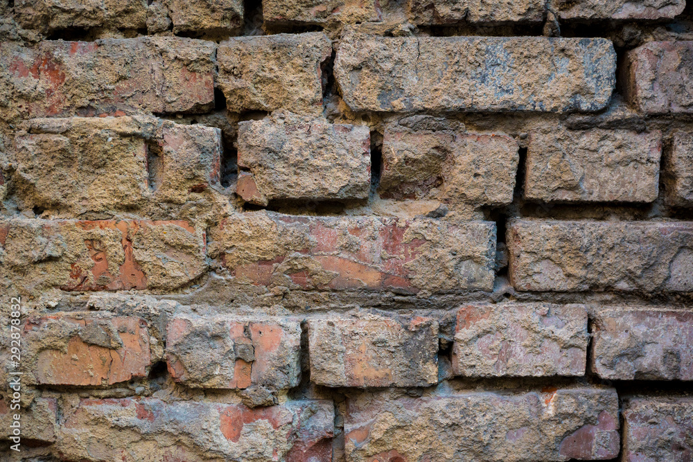 Texture of an old paint covered brick wall. Background image of an abandoned brick wall with painted over paint Texture of an old paint covered brick wall. Background image of an abandoned brick wall with painted over paint
