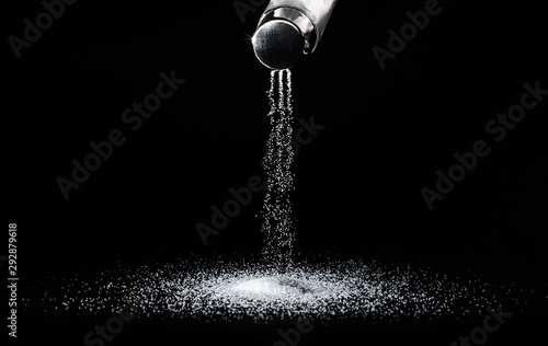 Salt shaker on a dark background photo