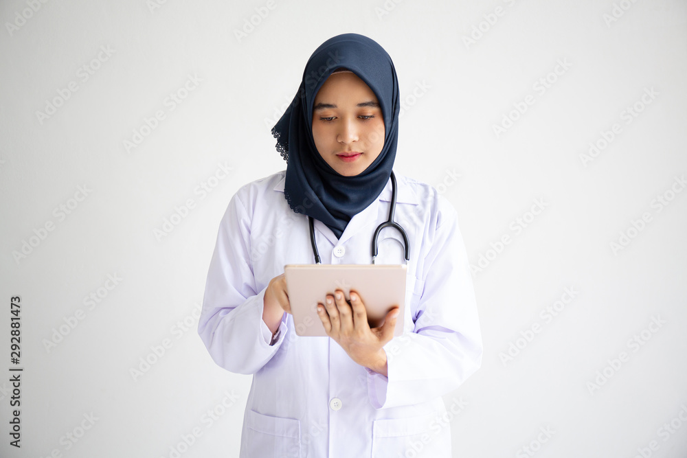 Young Arab Muslim intern doctor women smile on isolate white background concept for Islam people working in medical hospital health care, Modern Nurse wearing hijab in medico clinic business service. Young Arab Muslim intern doctor women smile on isolate white background concept for Islam people working in medical hospital health care, Modern Nurse wearing hijab in medico clinic business service.