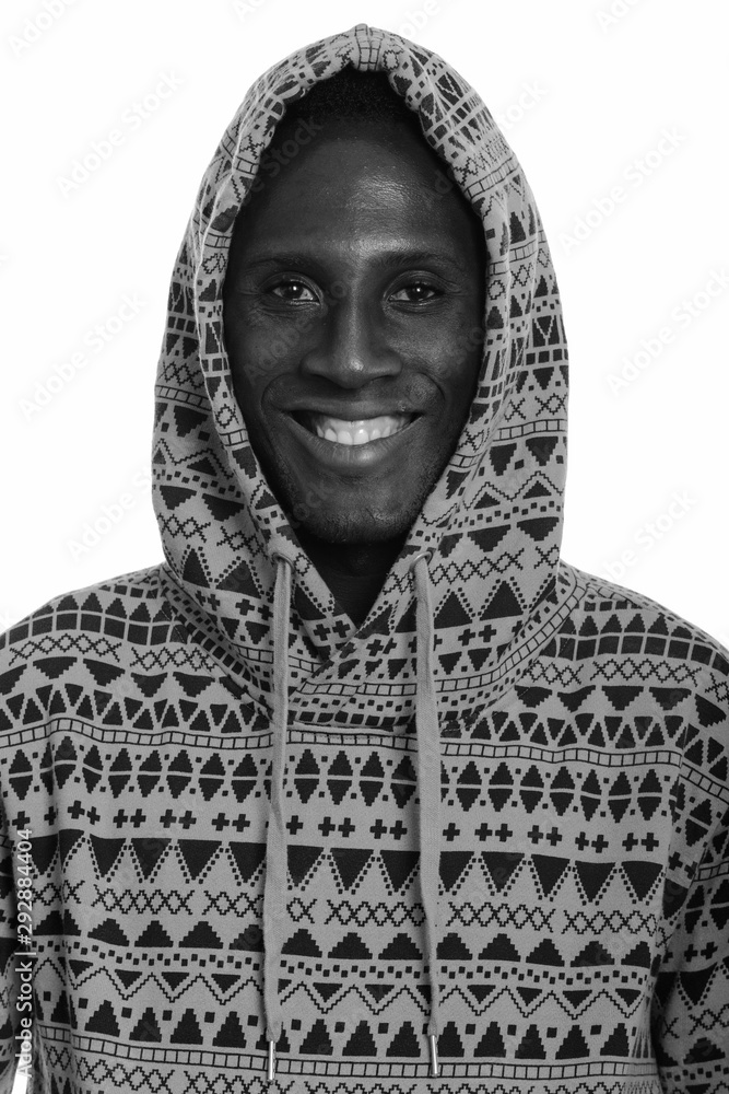 Face of young happy black African man smiling and wearing hoodie