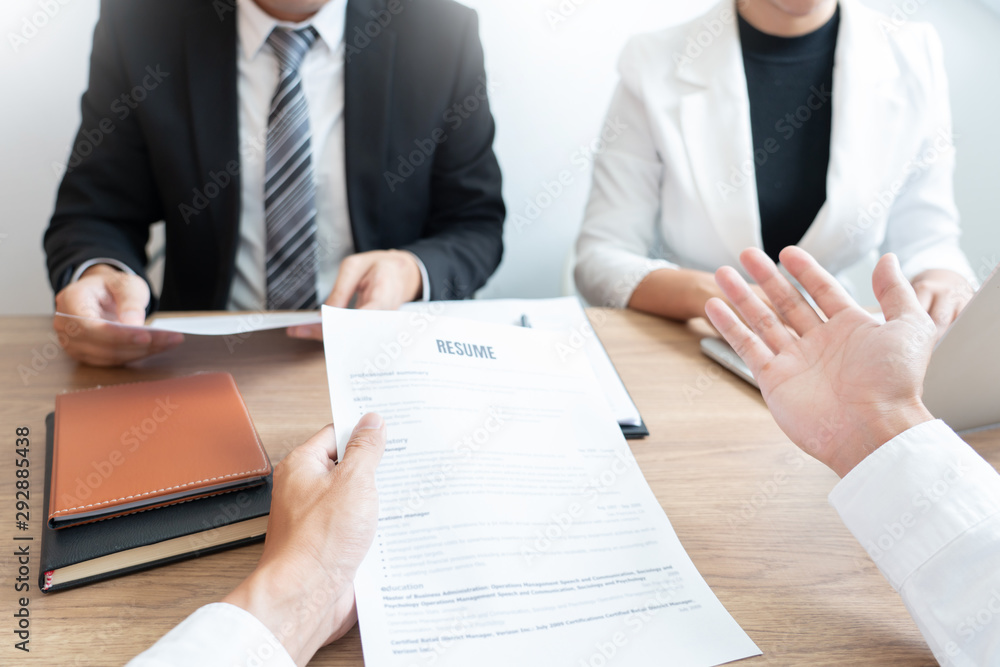 Serious man has a business meeting reading a resume about hiring decision during a job interview in company, attractive and professionally dressed, employment recruitment concept. Serious man has a business meeting reading a resume about hiring decision during a job interview in company, attractive and professionally dressed, employment recruitment concept.