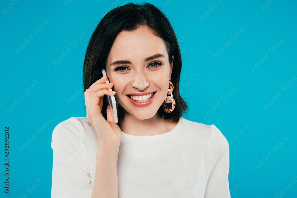 smiling elegant woman in dress talking on smartphone isolated on blue smiling elegant woman in dress talking on smartphone isolated on blue