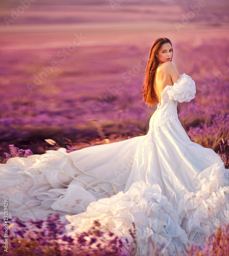 Beautiful bride posing at field of lavender photo