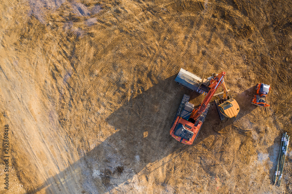 Aerial view over heavy machinery on a building construction site