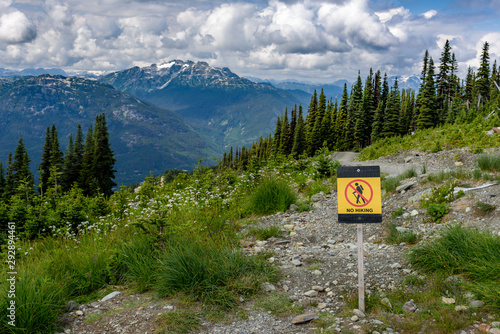 Wallpaper Mural A 'No Hiking' sign, on an alpine mountain, with snow capped mountains in the distance.  The sign is located on the Whistler mountain, Canada Torontodigital.ca