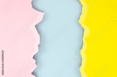 Top view yellow, blue and pink torn edges paper texture with copyspace for your text