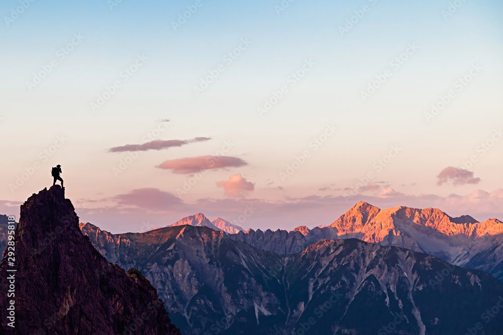 Hiker on top of a Mountain Looking to the Sunset - obrazy, fototapety, plakaty 
