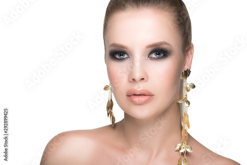 Large portrait of a girl with healthy and beautiful skin. Facial care and beautiful dark makeup. Isolated.