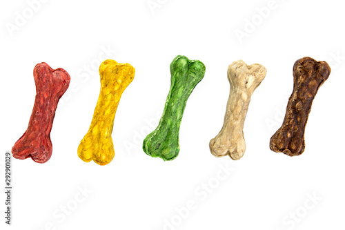 Colorful rawhide dog snack food isolated on white background. Row of multicolor rawhide dog food isolated