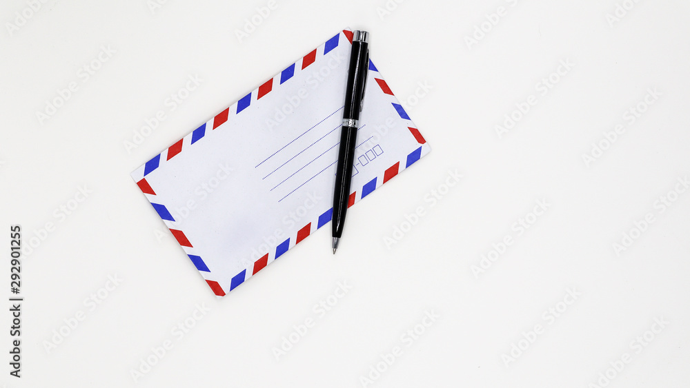 Airmail envelope and black pen on white background. Airmail envelope and black pen on white background.