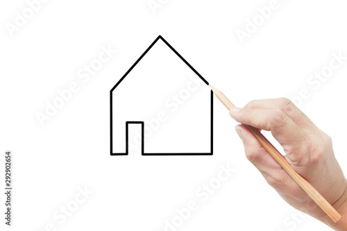 Hand holds pen for drawing house