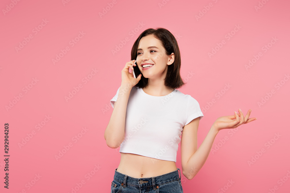 beautiful smiling girl talking on smartphone and gesturing isolated on pink beautiful smiling girl talking on smartphone and gesturing isolated on pink
