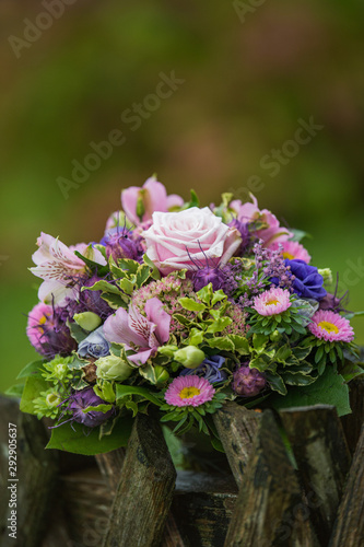 Colorful flower bouquet on a garden fence