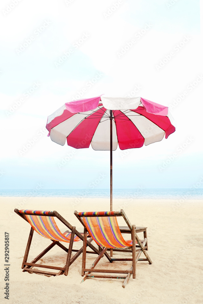 Blue sea and white sand beach with beach chairs and red parasol, Cha-am, Thailand - holiday and vocation concepts. COPY SPACE.