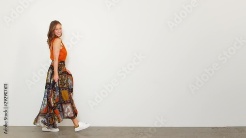 Slow-motion Woman in an Orange Sleeveless Top Swaying and Spinning Around