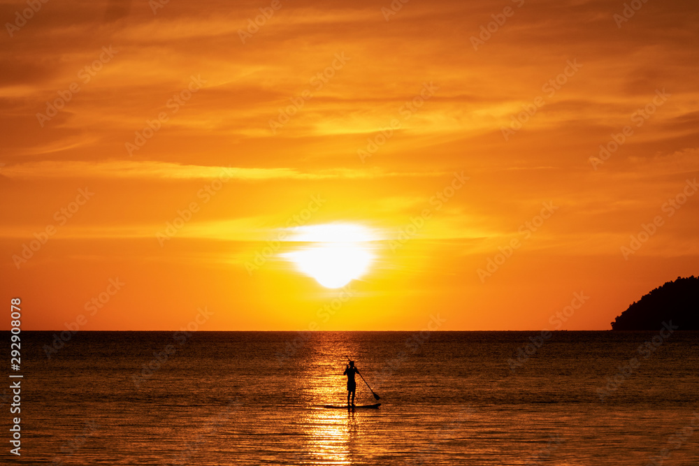 silhouette of a man in the sunset paddle boarding silhouette of a man in the sunset paddle boarding