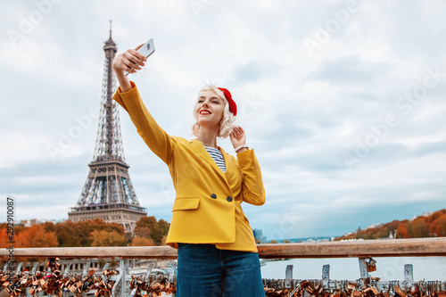 Photography Happy smiling tourist girl makes selfie in Paris with view of Eiffel tower