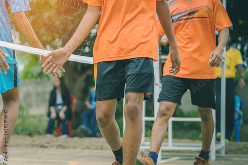 Students playing traditional asian sport game sepak takraw in school