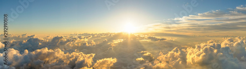 Panorama sunrise from the top of the mount Fuji. The sun is shining strong from the horizon over all the clouds and under the blue sky. good New year new life new beginning. Abstract nature background © Jirakit