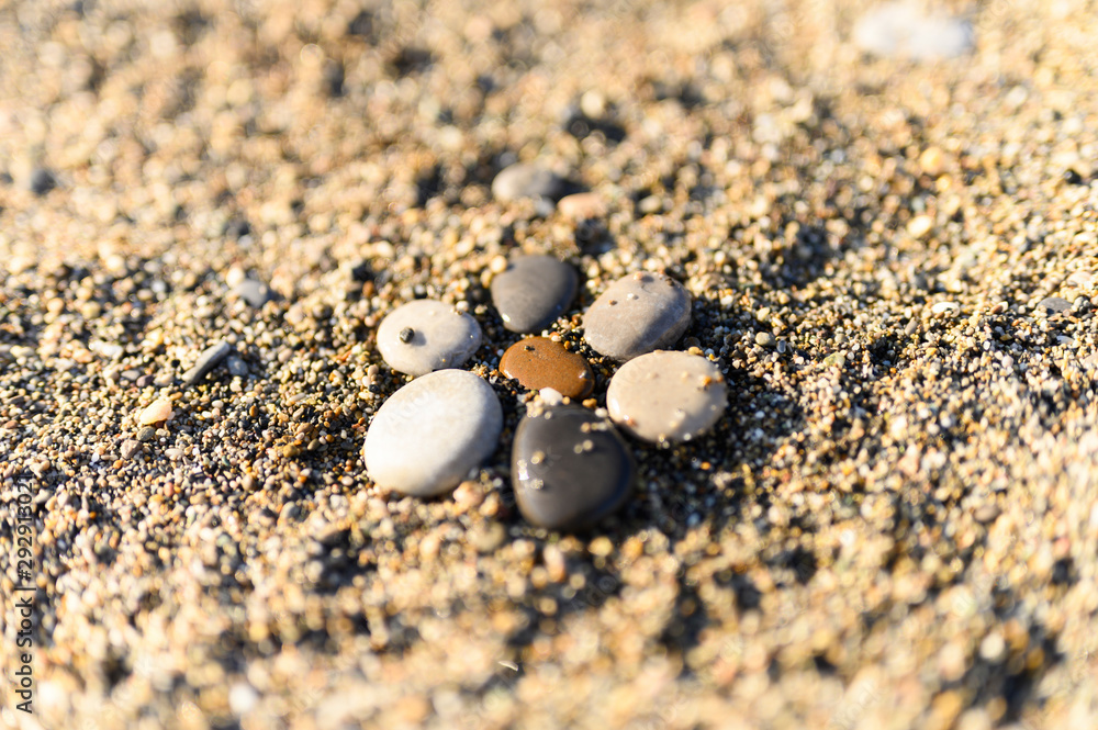 arrangement of colored sea stones and sand arrangement of colored sea stones and sand
